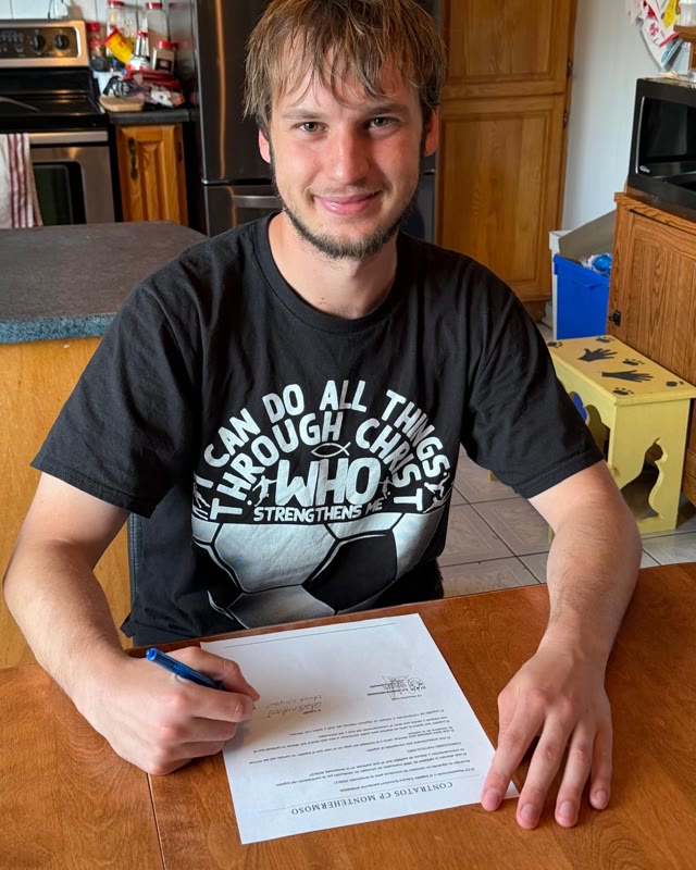 Edward signing his contract
